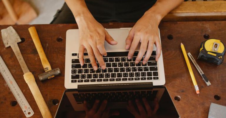 Types Of Tape - Faceless artisan typing on laptop in workshop