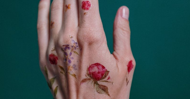 Temporary Installations - Photo of Flower Tattoos on Person's Left Hand