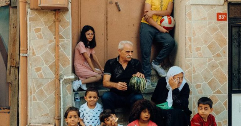 Community Projects - A group of people sitting on the steps of a building