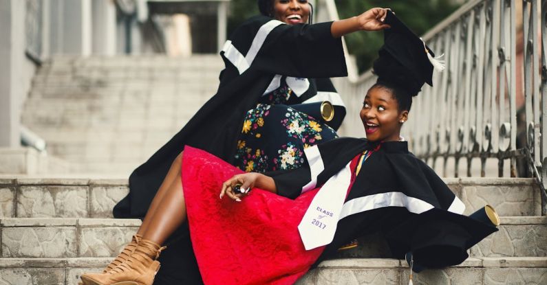 Removing - Shallow Focus Photography of Two Women in Academic Dress on Flight of Stairs