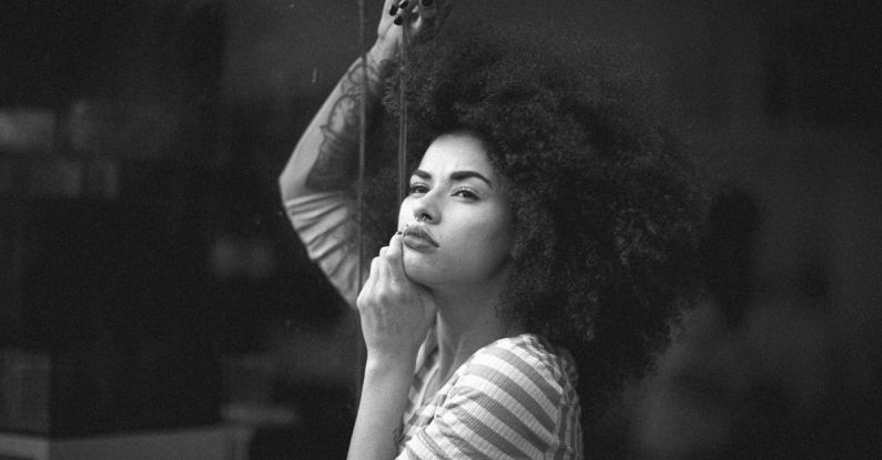 Monochrome - Grayscale Photo of Woman in Striped Long-sleeved Shirt