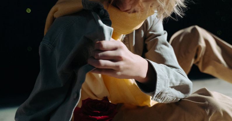 Protecting - A Woman Protecting a Rose with Her Jacket