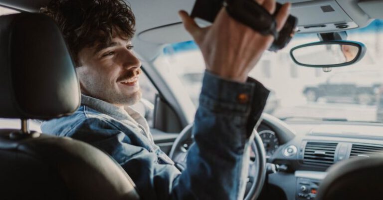 Documenting - A Man Sitting in a Car Holding a Camcorder